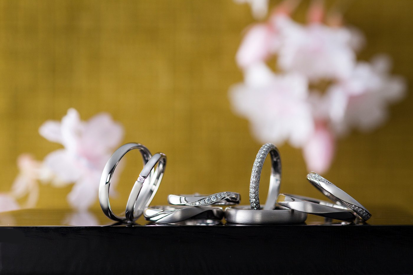 黒漆の上に並ぶ IRONOHA 彩乃瑞の結婚指輪